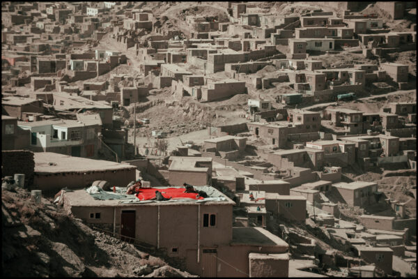 October 23, 2009 – Kabul, Afghanistan.
On the hills overlooking Kabul, a group of women gathers on the rooftop, preparing what appears to be elements of a wedding ceremony. Sitting together on a patterned quilt, they share a quiet moment of focus, tradition, and sisterhood.
This intimate scene reflects the resilience of Afghan women — upholding rituals and culture in the heart of a transforming city.
Photo Damian Kramski
